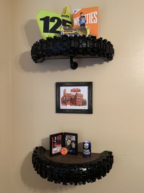 Turn old motorcycle tires into cool shelves for a man cave for child’s room! Moto Room Ideas, Motorcycle Room Aesthetic, Motorbike Bedroom Ideas, Motorbike Theme Bedroom, Dirt Bike Themed Room, Auto Shop Decor, Dirt Bike Tire Shelf, Motocross Themed Bedroom, Motorcycle Nursery Theme