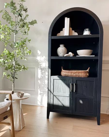 My arched cabinet. Such great quality and I love the black!! Looks so beautiful against my wooden floors! Linking some of my favorite home styling pieces and home accents! Black Arched Cabinet Living Room, Arch Cabinet Styling, Black Bookcase Styling, Black Arched Cabinet, Hallway Table Decor, Arched Cabinet, Arch Cabinet, My Texas House, Black Bookcase