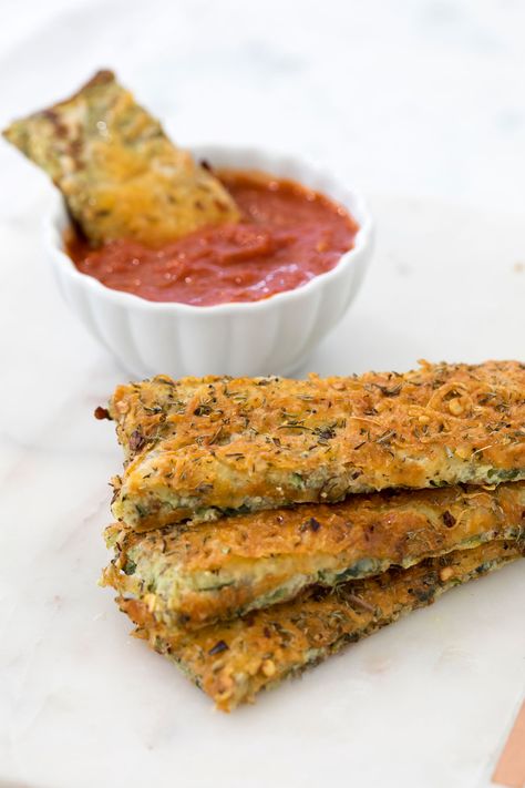 I created the recipe for these cheesy zucchini breadsticks when I was finishing my masters at NYU two years ago. It reminds me of the breadsticks we used to order from pizza places when I was younger, only much lighter! I have tried this recipe with organic wheat bran and pulverized GG crackers – both ways taste good! Dip the breadsticks with warmed up marinara sauce and enjoy! Cheesy Zucchini Breadsticks Serves 4 INGREDIENTS 3 medium zucchini, grated 4 GG crackers, pulverized or organic wheat Zucchini Crackers, Zucchini Breadsticks, Wasabi Mashed Potatoes, Factor Recipes, Gg Crackers, Low Calorie Appetizers, Low Carb Veggie, Breadsticks Recipe, Low Carb Marinara