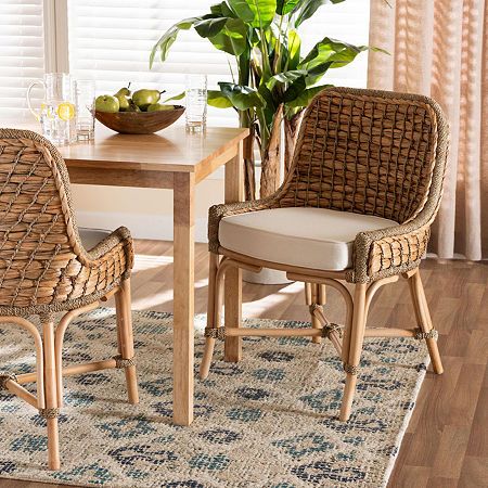 Bestow an air of ease to your space with the calm, soothing tones of the Kyle dining chair. Made in Indonesia, this chair is comprised of natural rattan semi pole frame embellished with handcrafted seagrass weave. Its seat features a removeable fabric upholstered cushion for outstanding comfort. The Kyle will arrive fully assembled and utilizes angled legs connected by a crisscross base for excellent stability and support. Capturing the luxurious comfort of a tropical escape, the Kyle dining ch… Lakehouse Design, Boho Dining Chairs, French Country Dining Chairs, Dining Room Cozy, Tufted Dining Chairs, French Country Dining, Wicker Dining Chairs, Rattan Dining, Rattan Dining Chairs