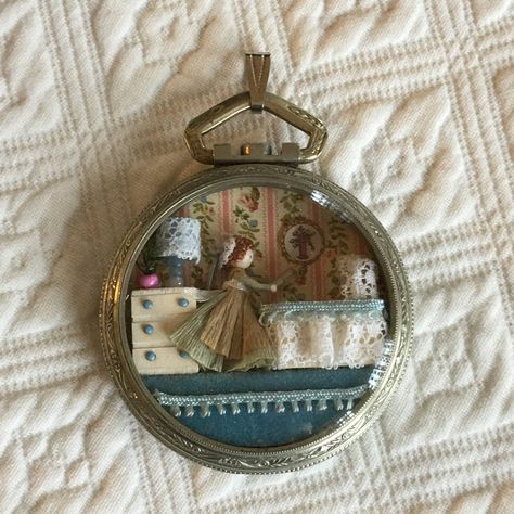 "Vintage Pocket Watch Pendent With Miniature Scene of Mother With Baby in Bassinet, Dresser, Lamp, Wall Paper& Plant. Charming Mini Scene. Mini Diorama. Scene Inside of a Pocket Watch Case. This is a charming little miniature scene to be displayed on a chain you wear or sit on a mini shelf.  Sizes: 2\" Watch Case, 2 3/4\" With Pendent Hanger For Other Crafting, Vintage and Handmade Items See:  www.VeryVictorianStudio.etsy.com For Sewing related items see my other shop: www.SewingRoomStore.etsy.c Lamp Wallpaper, Dresser Lamp, Wallpaper Plant, Mother With Baby, Mini Diorama, Compact Art, Mini Shelf, Matchbox Crafts, Paper Plants