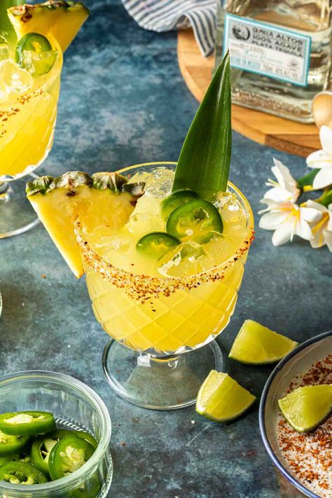 Made with fresh pineapple juice and poblano liqueur, this spicy pineapple margarita is an exciting, tropical twist on the classic tequila cocktail. This refreshing margarita is served on the rocks and garnished with fresh jalapeño and a salted chili rim. Virgin Mocktail, Traditional Margarita Recipe, Spicy Pineapple Margarita, Classic Tequila Cocktails, Pineapple Margarita Recipe, Margarita Mocktail, Negroni Recipe, Spicy Pineapple, Spicy Drinks