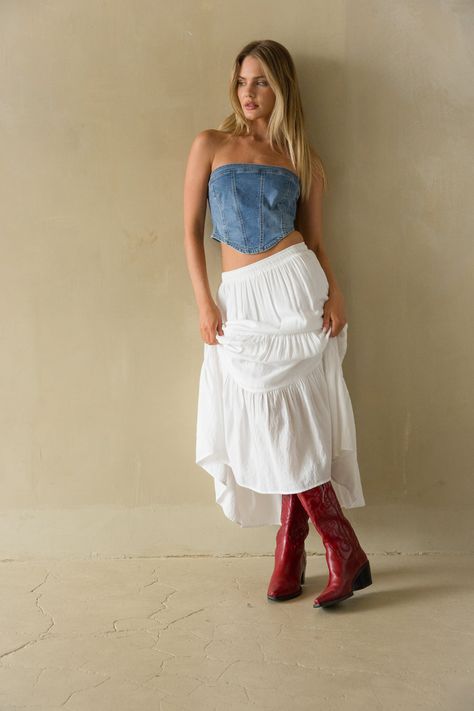 The Pippa Strapless Denim Corset Top is an edgy must-have! This strapless corset features a pointed hem, cropped fit, and denim finish! Pair this casual chic top with the Hope Tiered Maxi Skirt to complete the look!Details: 72% Cotton, 24% Polyester, 3% Rayon, 1% Spandex Back zipper Silicone grips Some stretch Hand wash cold/ Lay flat to dry Maxi Skirt And Crop Top Outfit, Denim Top White Skirt, Denim Western Outfits Women, Outfits With Denim Top, Strapless Denim Top, Cowboy Boots With Skirt Outfit, Flowy Denim Skirt Outfit, Coachella Outfit Denim, Denim Country Outfits