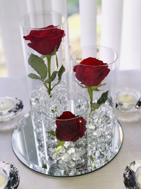 Create this beautiful rose centrepiece with our trio cylinder vasesgel beads and roses Red Quince Centerpieces Simple, Vase With Gel Beads, Red Rose Centrepiece, Rose Vase Centerpieces, Simple Red Centerpieces, Red Rose Centerpieces Simple, Red And Gold Wedding Centerpieces, Valentine Tablescape Centerpiece Ideas, Roses Centerpieces Ideas