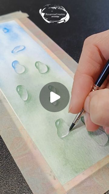 Watercolor tutorials and affordable art ❤️ on Instagram: "Trying out raindrops for the first time! How do you think I did? . . Paper: Baohong coldpressed Paints: Qor & Van Gogh Brushes: Silver Black Velvet . . #watercolorraindrops #raindropspainting #watercolorwaterdrops #waterdropspainting #droplet #dropletpainting #watercolorbookmark #bookmarkpainting #bookmarkart #simplewatercolor #simplewatercolorpainting #easywatercolors #watercolorfun #artvideo #watercolor #watercolorvideo #aquarela #waterverf #aquarelle #watercolortutorial" Watercolor Dropper Art, How To Paint Water Drops In Watercolor, Watercolor Water Droplets, Watercolor Water Drops, Watercolor Bubbles Tutorials, Watercolor Stained Glass Painting, Raindrop Watercolor, Watercolor Bubbles Painting, Raindrop Painting