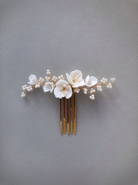 Delicate and stunning floral comb is crafted with handmade Porcelain flowers and small matte beads. Use this flower hair comb to accentuate an updo or add a whimsical touch to loose waves. So small the comb is well attached and holds even on short hair (if necessary, it can be fixed with a bobby pin). This bridal hair piece is versatile and can complement any wedding gown design. Available on silver and gold wire. Length: 9 cm ( 3.5 inch) If you like this bridal hair comb, I recommend that you s Floral Hair Pins Hairstyles, Tropical Wedding Hair Piece, White Flower Hair Accessories, Wedding Hair Decoration, Hair Accessories Bride, Bridal Hair With Comb, Flower Head Piece, Floral Hair Piece Wedding, Bridal Floral Hair