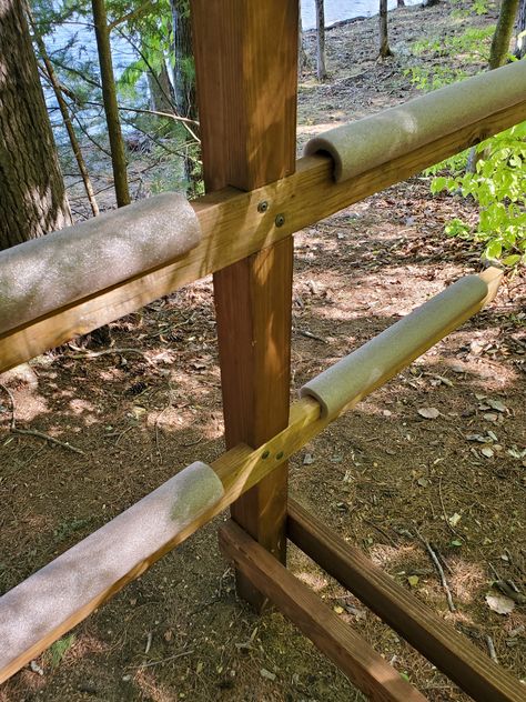 Homemade Kayak Rack made out of wood.  Boat storage for kayaks, canoes and paddle boards.  Foam noodles to protect against damage. Canoe Kayak Rack, Canoe And Kayak Storage Rack, Outdoor Kayak Rack, Wood Kayak Rack, Kayak Stand Diy Storage Racks, Kayak Rack Diy Wood Plans, Diy Canoe Rack, Outdoor Kayak Storage Diy, Kayak Racks For Storage