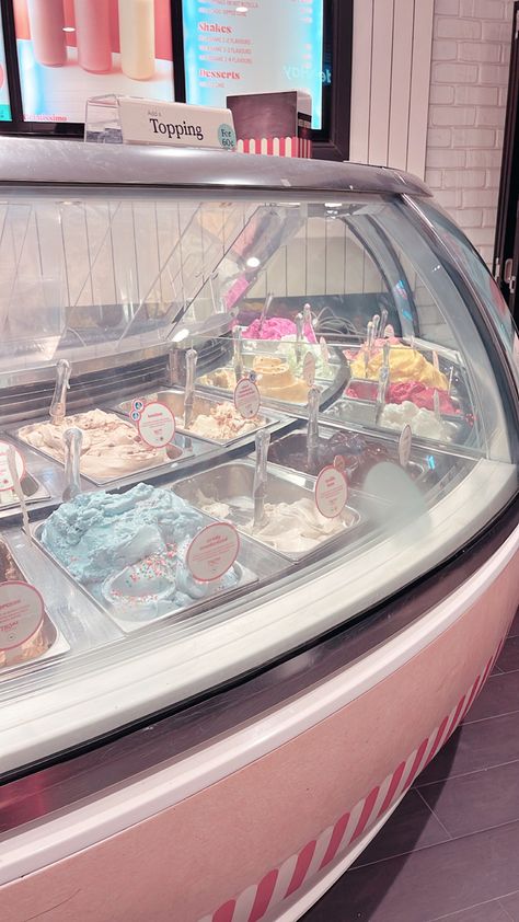 Pastel ice cream parlour with many flavours of ice cream in a glass case Ice Cream Maker Aesthetic, Japan Ice Cream Shop, Pink Ice Cream Aesthetic, Japanese Ice Cream Shop, Beach Ice Cream Shop, Ice Cream Store Aesthetic, Ice Cream Parlor Aesthetic, Ice Cream Shop Aesthetic, Cute Ice Cream Shop