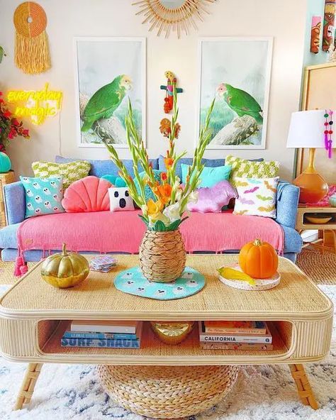 A dopamine decor living room with a blue sofa and colorful pillows, a cane coffee table, bold decor and artwork Hawaiian Home Decor Living Room, Colorful Beach Decor, Cheerful Living Room, Bright Sofa, Colorful Beach House, Summer Living Room Decor, Summer Living Room, Home Decor Cozy, Colourful Living Room Decor