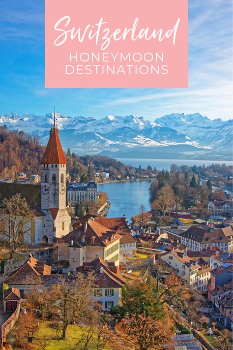 Aerial view of the medieval Switzerland city of Thun on a lake with snow-capped mountains in the background. A pink text box at the top reads, "Switzerland Honeymoon Destinations" Honeymoon Destinations Switzerland, Switzerland Honeymoon Winter, Switzerland Honeymoon Romantic, Honeymoon In Switzerland, Scandinavian Honeymoon, Honeymoon Switzerland, Fire Gazing, Swiss Honeymoon, Switzerland Honeymoon