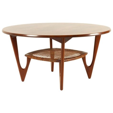 Vintage Danish rosewood coffee table by Kurt Østervig for Jason Møbler, 1950s. Rare and elegant Mid-Century Modern round coffee table with cane shelf. Sculpted V-shaped legs in dark solid teak. Designed by renowned Danish architect Kurt Østervig in the early 1950s. Perhaps the most beautiful coffee table ever designed in the golden age of Scandinavian furniture design. Amazing and expressive rosewood grain on the tabletop. A very rare find in this condition. Exceptional good original condition. 1950s Coffee Table, 1950s Table, Om Kalthoum, Modern Round Coffee Table, Cane Shelf, Colorful Coffee Table, Terrace Furniture, Danish Coffee Table, Pine Coffee Table