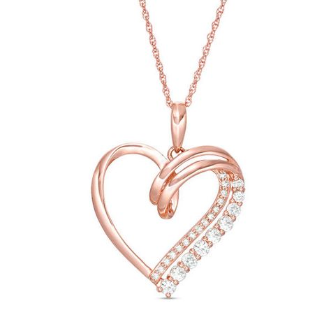 Shimmering and sweet, this heart pendant is a romantic look she’ll love to wear. Crafted in precious 10K rose gold, this beautiful style features an artfully sculpted heart outline with a looped double ribbon along one side. One ribbon sparkles with petite diamonds, the other with graduated-size lab-created white sapphires. Radiant with 1/15 ct. t.w. of diamonds and a bright polished shine, this pendant suspends along an 18.0-inch rope chain that secures with a spring-ring clasp. Wedding Necklace Designs, Jewelry Goals, Concept Jewelry, Heart Pendent, Simple Jewellery, Beautiful Pendants, Diamond Pendants Designs, Heart Outline, Heart Necklace Diamond