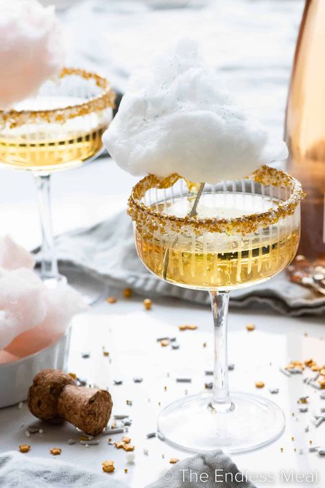 This cotton candy champagne is bubbly, sweet, and perfect for parties! It's sparkling wine served in a sprinkle-rimmed glass, then topped with a cloud of cotton candy. It'll take your party to the next level, and it's ready in minutes! #theendlessmeal #cocktail #drinks #cottoncandy #champagne #celebration Nye Champagne, Champagne Recipes, Maple Cotton Candy, Cotton Candy Cocktail, Champagne Recipe, Sweet Champagne, Cotton Candy Champagne, Cocktail Party Decor, Sparkling Juice