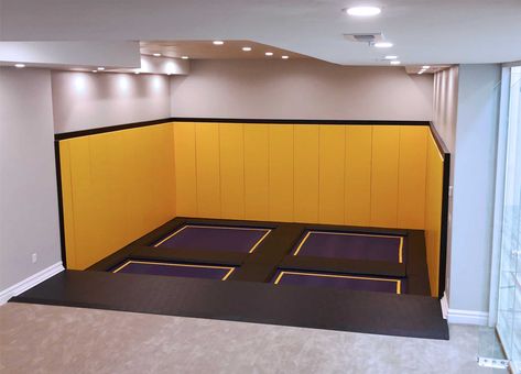 Bring the heart pumping entertainment of a trampoline park to your indoor play space. Inspired by trampolines found at family entertainment centers, our team helped this homeowner incorporate a trampoline court into his newly built recreation room. Custom designed for his space, we incorporated premium grade wall pads, purple trampoline beds with yellow stripes and a durable frame pad that protects kids from the trampoline springs and frame. Sunken Trampoline, Rectangle Trampoline, Indoor Playground Design, Trampoline Room, Indoor Playroom, Backyard Trampoline, Indoor Trampoline, Heart Pumping, House Games