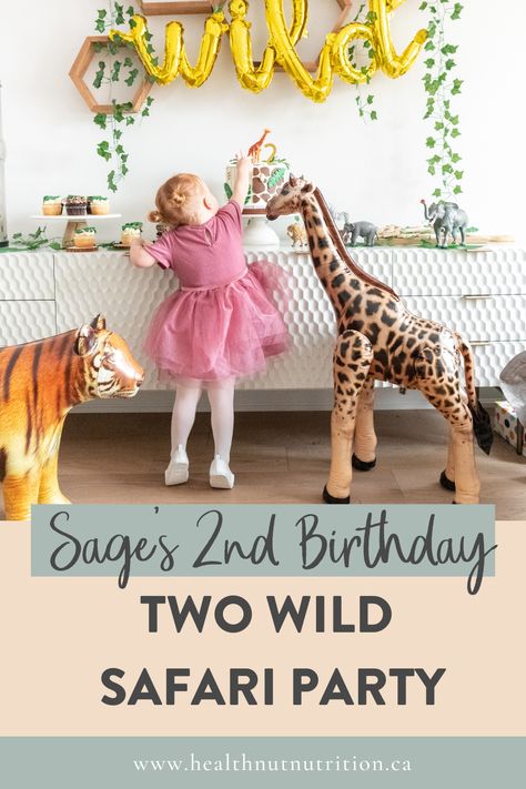 Two wild birthday party decorations over a table with the birthday girl getting a taste of cake. Wild Safari Birthday Party, Zoo Birthday Party, 2nd Birthday Party For Girl, Birthday Party Girl, Wild Birthday Party, Zoo Birthday, Two Wild, Wild Safari, 2nd Birthday Party Themes