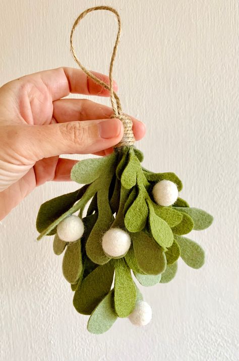 Individual Handmade Felt Christmas Mistletoe Ornament This beautiful handmade Christmas decoration can be hung on your Christmas tree or anywhere around the house to bring a bit of festive cheer! Each ornament is handmade from moss and sage coloured wool felt, decorated with individual white felt balls. Each ornament measures approx 20cm in height including a traditional brown twine hanging loop of approx 7cms. Please be advised that this is a decorative ornament and not a toy and should be kept Winter Handmade Decorations, Hanging Felt Decorations, Felt Winter Crafts, Christmas Felt Decorations Hand Sewn, Christmas Ornaments Felt Diy, White Felt Christmas Decorations, Felt Christmas Tree Craft, Sew Christmas Decor, Christmas Tree Toys Diy