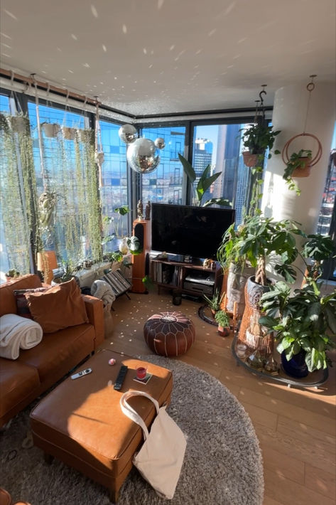 Filled with plants, flooded with natural light, bohemian interior design, boho, house plants, disco ball, hanging plants, nyc, manhattan skyline, crystals, Monstera, birds of paradise, succulents, Monstera, Highrise building, luxury apartment inspo, Manhattan Views, Apartment with city views Crochet Curly Hair, Boho Apartment, Bohemian Apartment, Nyc Penthouse, Boho Apartments, Vintage Apartment, Cosy Apartment, Curly Crochet Hair Styles, Cosy Room