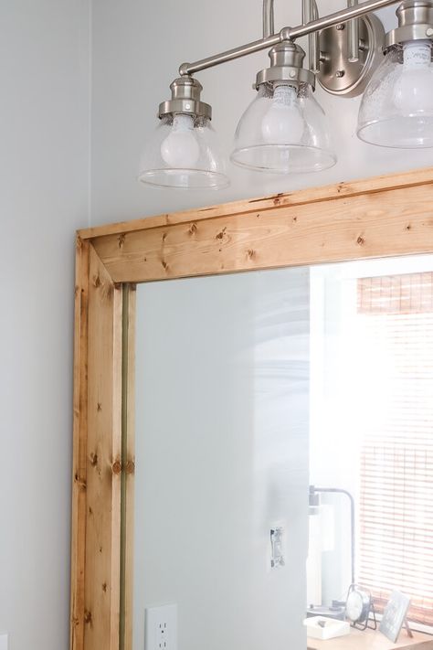 Wood Trimmed Mirror Bathroom, Diy Frame Bathroom Mirror With Clips, Diy Wood Framed Mirror Bathroom, Diy Farmhouse Mirror Bathroom, Thick Mirror Frame, Frame A Bathroom Mirror With Clips, Sheet Mirror In Bathroom, Framing A Bathroom Mirror With Wood, Contractor Grade Mirror Makeover