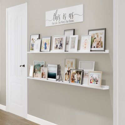 These wood shelves for walls will help you to transform any dull space into wall art! You will receive 2 narrow wall bookshelves. Install them the way you want and display your favorite pictures, family photos, and more to complete your home decor. | Latitude Run® DENVER Ledge, 84" White, 2Pcs Wood in Brown / White, Size 1.6 H x 84.0 W x 1.6 D in | Wayfair | Home Decor White Long Shelf, Floating Shelves With Pictures Around, Bedroom Photo Shelf, Ledge Picture Shelves, Wood Picture Shelves, Floating Shelves With Frames, Floating Shelf Wall Collage, Memory Corner At Home, Wedding Photo Display Shelf