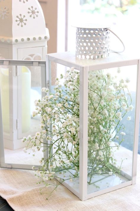 Hardy yet willowy baby's breath gives an angular lantern a secret-garden vibe. Get the tutorial at Melissa Creates »  - GoodHousekeeping.com Spring Lantern Decor Ideas, Spring Lantern Decor, Spring Lantern, Tall Lanterns, Large Lantern, Rustic Arrangements, Lantern Decor, Bunny Eggs, Candle Wedding Centerpieces