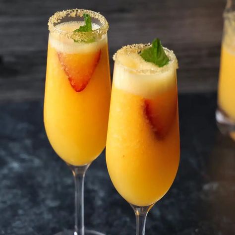 Easy Frozen Peach Bellinis • Flavor Feed Bookmark Icon, Refreshing Drinks Alcohol, Frozen Peaches, Peach Vodka, Seasoned Veggies, Brunch Drinks, Mixed Drinks Alcohol, Peach Bellini, Alcoholic Beverage