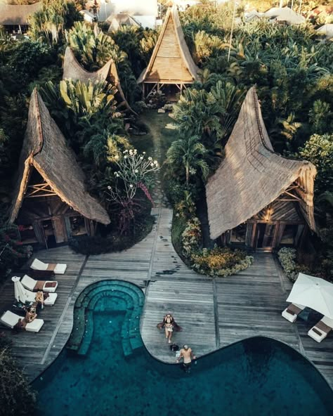 Beautiful golden hour drone shot of Own Villa - located between Canggu and Seminyak in Bali, Indonesia - recycled wood, curved infinity pool, and lush tropical greenery make up this intimate and unique eco-resort #concioustravel #travel #beautifuldestinations #wheretostay #balivilla #balihotel #designhome #architecture #design #archilovers #uniquearchitecture #creativelife Bali Resort Architecture, Bali Resort Villa, Eco Resort Architecture, Tropical Resort Design, Jungle Resort, Voyage Bali, Villa Bali, Bali Resort, Resort Architecture