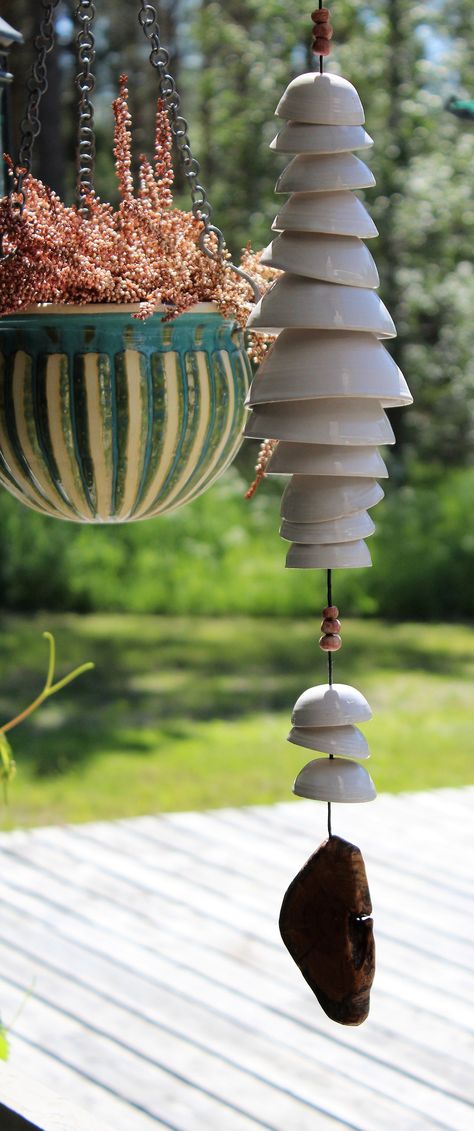 HANDMADE CERAMIC WIND CHIME Ceramic wind chime with a wooden disc at the bottom. The cups are wheel thrown one by one, and hand glazed. Two colour options. ✽ DIMENSIONS ✽ Length: 23.6-25.6 in (60-65 cm) Width: 3.1-3.9 in (8-10 cm) ✽ CARE INSTRUCTIONS ✽ Recommended to take indoors for the winter. During the summer fine outside. ✽ ENVIROMENTALLY FRIENDLY SHIPPING ✽ I ship all my products from Finland. Shipping abroad will take approximately 1-3 weeks. Most of the packing materials I use have been Art Auction Projects, Miniature Pottery, Ceramic Bell, Sculptures Céramiques, Diy Wind Chimes, Garden Pottery, Hand Built Pottery, Pottery Crafts, Diy Pottery