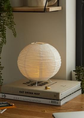 Inject a warm glow into your space with this easy battery-operated lamp. The globe-shaped paper lamp features a low-key lantern design with a rice paper exterior and lightweight metal frame. Complete with a built-in LED bulb that'll emit a cosy yellow light wherever you place the lamp. **Content + Care** \- Rice paper, Plastic, Iron \- Wipe clean \- Requires 3 x AA batteries (not included) **Size** \- 20cm x 20cm x 20.5cm | Urban Outfitters Globe Paper Lantern - White 20cm x 20cm x 20.5cm Japandi Lighting, Rice Paper Lamp, Lanterns Bedroom, White Paper Lanterns, Japandi Interior Design, Unique Table Lamps, Uni Room, Pinterest Contest, Japandi Interior