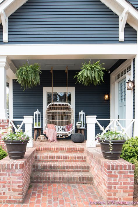 Our Fun & Colorful Bohemian Spring Porch Update Reveal...  dark-blue-gray-craftsman-exterior-paint-home-front-porch-decor-ideas-styling-outdoor-furniture-rattan-swing-lanterns Craftsman Front Porch Ideas, Craftsman Front Porch, Front Door Paint Colors, Craftsman Exterior, Stone Floor, Door Paint Colors, Spring Outdoor, Painted Front Doors, Craftsman Style Homes