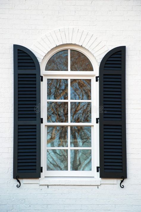 Shuttered Window. An arched window reflects a blue winter sky , #AD, #arched, #window, #Shuttered, #Window, #winter #ad Small Arched Windows, Arch Window Shutters, Arched Window Exterior, Shutters On Arched Windows, Arched Shutters Exterior, Arch Windows Exterior, Bricks Painted White, Dark Blue Shutters, Arched Window Shutters