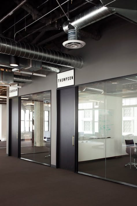 nameplate Industrial Office Door, Black Meeting Room, Exposed Ceiling Office, Meeting Room Signage, Modern Office Design Inspiration, Industrial Office Space, Exposed Ceiling, Room Signage, Industrial Office Design