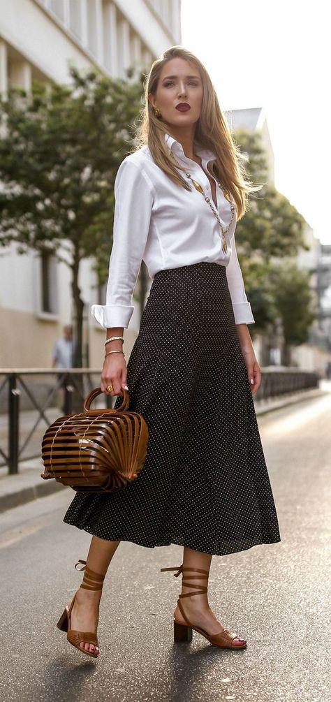 Looking put-together when the weather makes you want to fall apart isn’t easy. Here's your heat-proof uniform // White button-down shirt, black and white polka dot midi-skirt, wrap-around ankle strap open-toed sandals, vintage pendant necklace, gold statement earrings,open-top bamboo tote, workwear, affordable workwear{Chanel, Cult Gaia, Max Mara, Veronica Beard} Black Dress Ideas, Mary Orton, Sandals Vintage, Wear Black Dresses, Polka Dot Midi Skirt, Skirt Wrap, Vintage Pendant Necklace, 여름 스타일, Pendant Necklace Gold