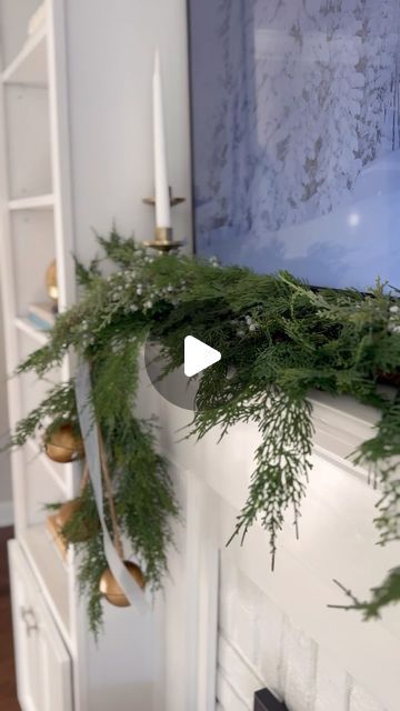 Taylor Collins Ash on Instagram: "Here's what I used to style our small space mantle for the holidays : - Two 6 ft. Faux Cedar Garlands from @studiomcgee - @command Cord Bundlers (one on the end + one in the middle of mantle) - 3 faux juniper & berry stems - large jingle bell strand - velvet ribbon (medium size) - bronze candlestick holders Everything linked over on my @shop.ltk -> https://liketk.it/4nyfY #ltkhome #ltkholidaystyle #ltkseasonal #holidaydecor #mantledecor #holidaygarland" Mantle Christmas Garland Ideas, No Garland Christmas Mantle, Garland On Console Table, Minimalist Christmas Mantle Decor, Cedar Garland Mantle, Bells Hanging From Mantle, Fireplace Garland And Bells, Mantle Garland With Bells, Christmas Mantel Garland Target