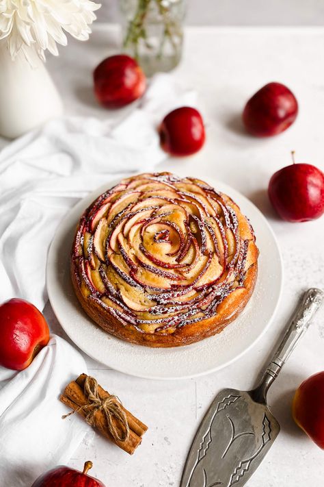 This apple rose cake is soft, tender and is topped with lots of sliced red apples arranged to form a rose! It's finished off with warm honey syrup and a light dusting of icing sugar. A stunning dessert for your table this Autumn! Rose Cake Recipe, Apple Rose Tart, Baking Competition, Gourmet Apples, Apple Rose, Thanksgiving 2023, Springform Pan Cake, Shana Tova, Rose Recipes