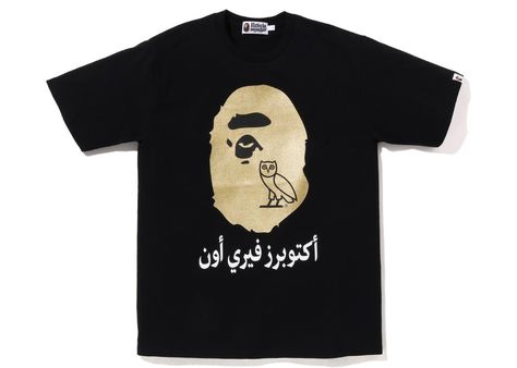 Please note: BAPE runs approximately one size small compared to traditional US sizing. We recommend moving up at least one whole size when purchasing BAPE apparel. | Men's BAPE x OVO Ape Head Tee Shirt in Black Gold Bape Black, Bape T Shirt, Bape Shirt, Arabic Text, Bathing Ape, A Bathing Ape, Jordan Retro, Casual T Shirts, Tshirt Logo