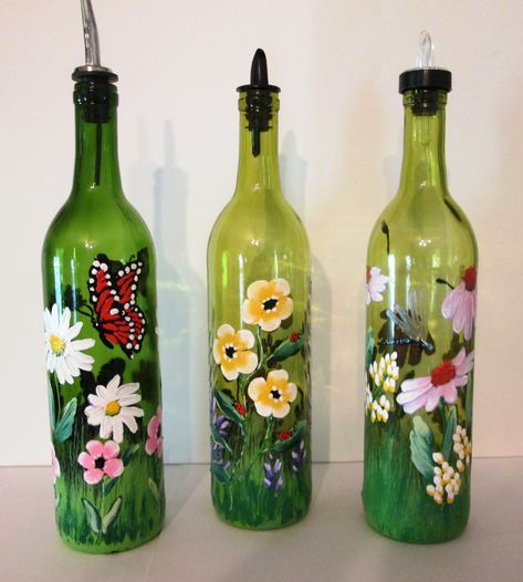 Vibrant painted wine bottles with butterflies, lady bugs and dragonflies Wine Bottle Project, Painted Glass Bottles, Hand Painted Wine Bottles, Empty Wine Bottles, Painted Bottle, Handmade Holiday Gifts, Wine Bottle Art, Glass Bottles Art, Painted Wine Bottles