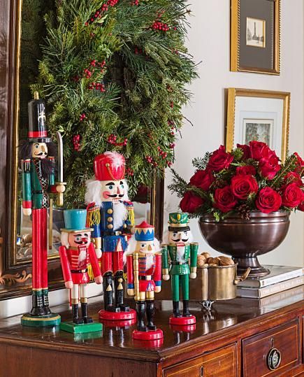 A collection of nutcrackers adds festive spirit to a chest of drawers. More Christmas decorating ideas: http://www.midwestliving.com/homes/featured-homes/holiday-house-tour-tailor-made-holiday/?page=6 Nutcracker Collection Display, How To Display Nutcracker Collection, Decorating With Nutcrackers, Nutcracker Display Ideas, Nutcracker Display, Classic Nutcracker, Holiday House Tours, Nutcracker Collection, Christmas Side