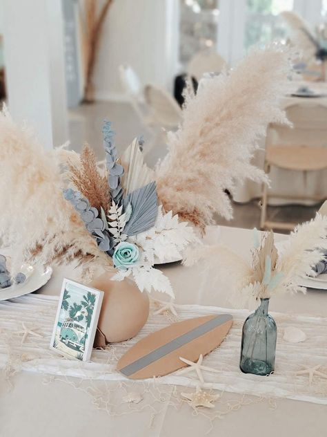 Baby on Board Baby Shower | CatchMyParty.com Beach Centerpiece Ideas, Baby On Board Centerpieces, Surfboard Centerpiece Ideas, Boho Beach Baby Shower Ideas, Beach Babe Baby Shower Theme, Surfer Boy Baby Shower Ideas, Beach Themed Baby Shower Ideas, Beach Theme Baby Shower Ideas, Surfer Baby Shower Ideas