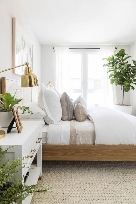 Bedroom features a wood and cane bed over a cream jute rug and a white and gold nightstand lit by a polished brass swing arm lamp. Cozy Bedroom Design, Gold Bedroom, Cottage Bedroom, White Sheets, Bilik Tidur, Interior Modern, Master Bedrooms Decor, White Bedroom, Room Inspiration Bedroom