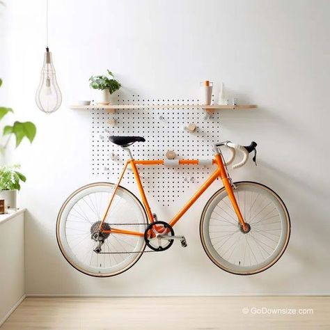 Designed as a pegboard, this rack offers a grid of holes that allow for flexible and adjustable bike storage. Bike Rack Apartment, Mudroom Bike Storage, Apartment Bike Rack, Indoor Bike Rack Apartments, Bicycle Display Ideas, Home Bike Storage, Bike Wall Mount Apartment, Indoor Bike Storage Ideas, Bicycle Storage Ideas Small Apartments