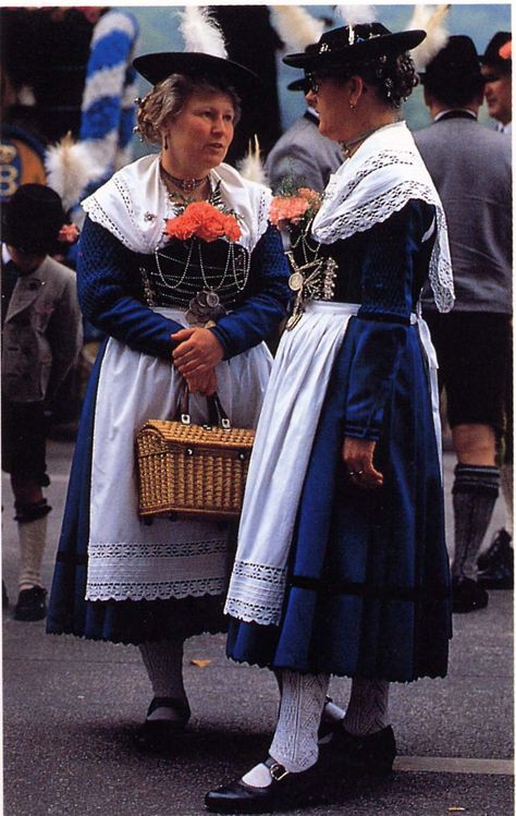 The women wear chain-laced bodices, a major feature of Bavarian dress, as are the hairpins and white lace shawls and aprons. - Ethnic Dress, Frances Kennett Bavarian Traditional Clothing, German Traditional Dress, Bavarian Outfit, Bavarian Costume, Bavarian Dress, Lace Shawls, German Dress, Costumes Around The World, Folk Dress