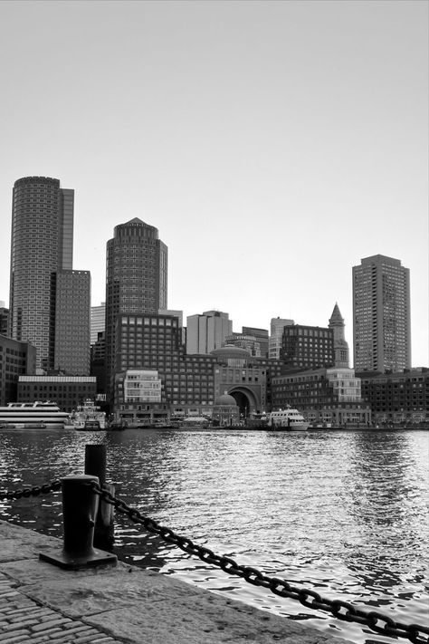 Black and white photo of the Boston Harbor in the foreground, the downtown Boston city skyline in the background just over the water. Boston Drawing, Boston Black And White, Boston Itinerary, Weekend In Boston, Boston Weekend, Massachusetts Aesthetic, Boston Aesthetic, Boston Neighborhoods, Boston Travel Guide