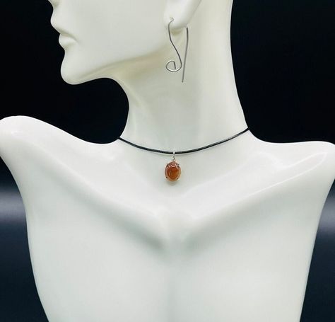 Discover a unique mix of styles with the Carnelian Necklace that brings vibrant energy. A Y2K necklace perfect for adding a nostalgic touch to your look. The pendant's black cord offers a minimalist yet bold statement, while the aesthetic necklace reflects your personal style. Protect yourself with the Evil Eye Necklace, crafted from sterling silver for elegance and charm. If you love gemstones, the Carnelian piece will provide rich, earthy tones. Elevate any outfit with the versatile Choker Nec Carnelian Choker, Choker Necklace Black, Necklace Y2k, Aesthetic Necklace, Y2k Necklace, Black Cord Necklace, Choker Designs, Gemstone Choker, Carnelian Jewelry