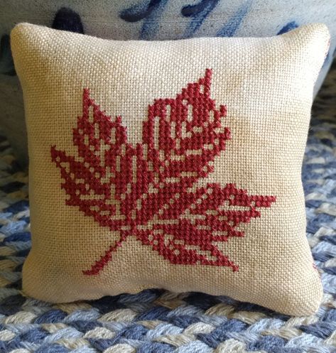 Small cross stitch autumn pillow with maple leaf. Maple Leaf Cross Stitch Pattern, Cross Stitch Cushions, Maple Leaf Cross Stitch, Cross Stitch Leaf, Cross Stitch Pillow Pattern, Cross Stitch Pillows, Leaf Cross Stitch, Cross Stitch Autumn, Autumn Cross Stitch