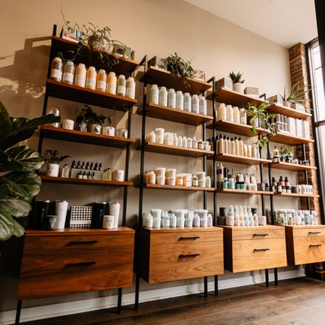 Salon Retail Display Interior Design, Small Spa Retail Display Ideas, Spa Shelving Ideas, Salon Retail Display Ideas Waiting Area, Natural Hair Salon Decor, Plants In Salon, Spa Merchandising Ideas, Spa Retail Shelves, Retail Area In Salon