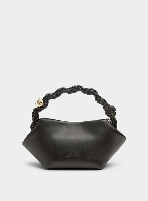 Accessories > Women > Bags Ganni - Bou Mini black braided handle recycled leather bag Ganni Founded by Ditte and Nicolaj Reffstrup, label Ganni combines its Scandinavian fashion roots with creativity and personality on pieces designed to stand out. Add an elegant finishing touch to your outfit with this small recycled leather bag showcasing an angular design and folded corners accented with a braided handle adorned with a signature golden die.   Blend of recycled leather, polyurethane and polyes Angular Design, Beauty Products Gifts, Linen Men, Bag Designs, Scandinavian Fashion, Floral Denim, Black Braids, Recycled Leather, Leather Bag Women