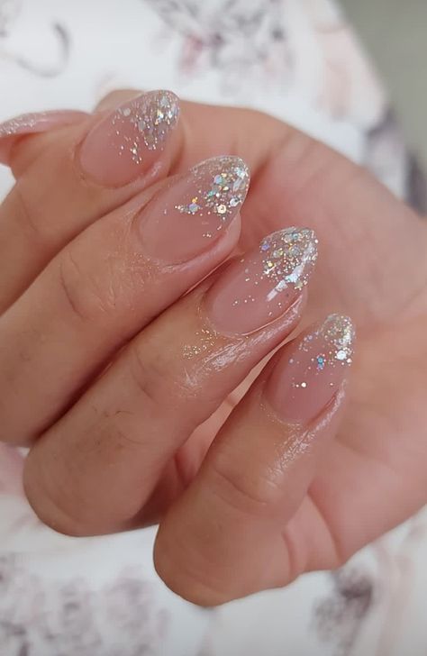 Silver Glitter French Tip Nails Almond, Nude Nails Glitter Tips, Prom Nails Simple Elegant, Clear Nails With Sparkles, White Sparkly Nail Designs, Sparkly Hoco Nails, Glittery Tips Nails, Falling Glitter Nails, Sparkle Tips Acrylic Nails