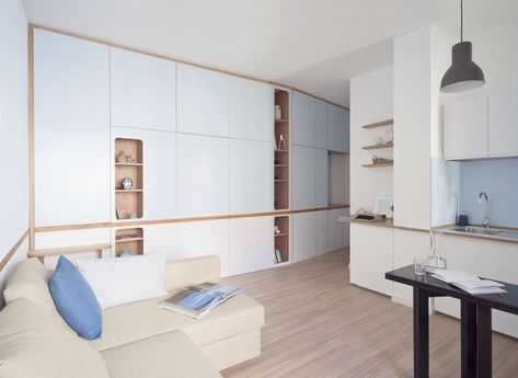 Inspired by boat design, this all\u002Din\u002Done wall hides two extra rooms in this small apartment in Italy. Raised Bedroom, Light Hardwood Floors, Tiny Apartments, Small Studio Apartment, Studio Flat, Tiny Studio, Japanese Interior Design, Diy Ikea, Built In Furniture