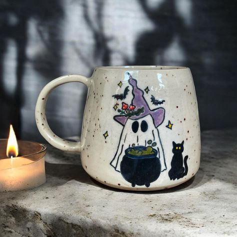 Boo! 🦇🕸️ It’s always halloween season for me ✨🍂 #londonpotters #ceramics #ceramicart #autumn #autumnvibes #stoneware #wheelthrown #coffee #coffeetime #coffeelover #coffeeshop #mug #coffeemug #tableware #pottery #ceramicstudio #ceramiclove #handmadeceramics #beginnerpotter #halloween #londonartist #handmadepottery #mugs #functionalceramics #handthrown #handcrafted #handmademug #pottersofinstagram #wheelthrowing Autumn Mug Painting Ideas, Halloween Mugs Diy, Autumn Mug Painting, Pottery Mugs Painting Ideas, Halloween Ceramic Painting, Ceramic Painting Halloween, Halloween Mug Painting Ideas, Halloween Pottery Painting Ideas, Fall Mug Painting Ideas