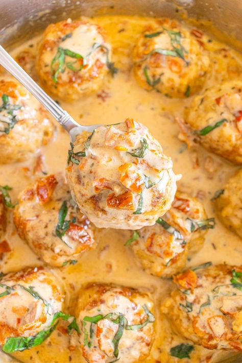 Whip up some marry me chicken meatballs and set the table in just 35 minutes. These juicy chicken meatballs smothered in a rich, creamy sauce are so good, they might just lead to a proposal! This dish perfectly balances cozy comfort food with a touch of gourmet flair. You'll love the classic Italian flavors, featuring zesty sun-dried tomatoes, fragrant herbs, and delicious parmesan cheese. It’s a fantastic flavor mix that’s sure to warm the hearts of everyone at the dinner table. Marry Me Chicken Meatballs Recipe, Chicken Meatballs With Sauce, Marry Me Meatballs, Marry Me Chicken Meatballs, Amaretto Chicken, Chicken Meatball Dinner, Chicken Meatballs Meal, Chicken Piccata Meatballs, Chicken Meatball Recipe